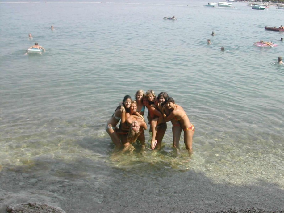 7 girls topless group shot on the beach 