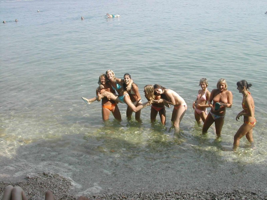 7 girls topless group shot on the beach 