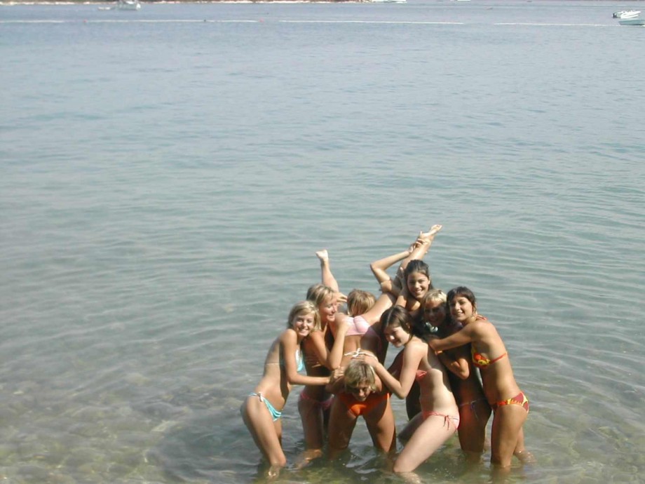 7 girls topless group shot on the beach 