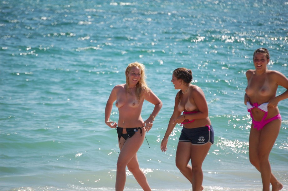 7 girls topless group shot on the beach 