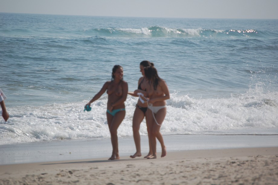 Three teen girls blend in on a nudist beach