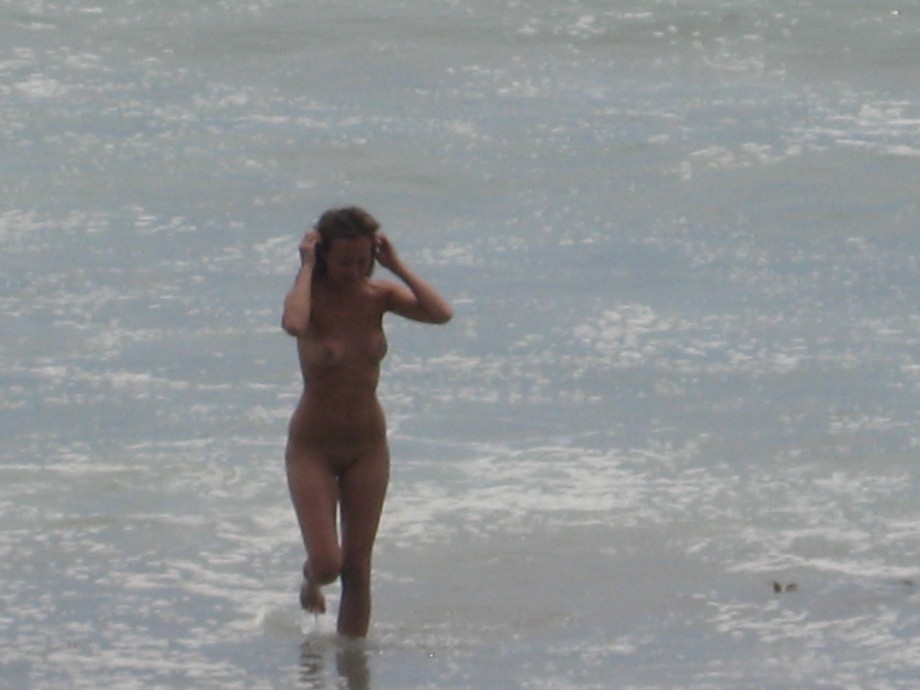 Brunette with pierced nipples on nudist beach