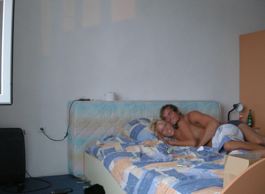 Blonde girlfriend pose on bed on vacation