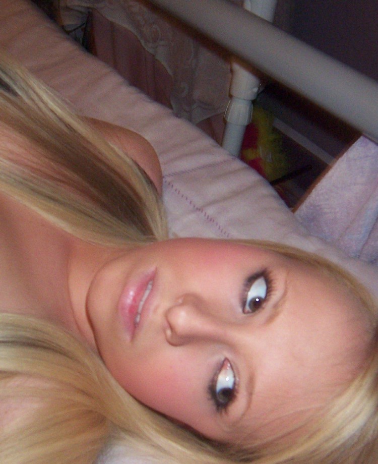 Selfshot blond in purple room