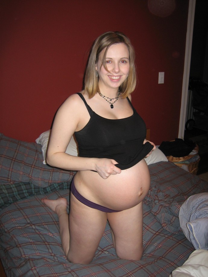 Cute pregnant blonde posing